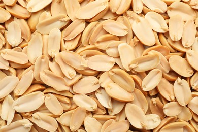 Photo of Fresh peeled peanuts as background, top view