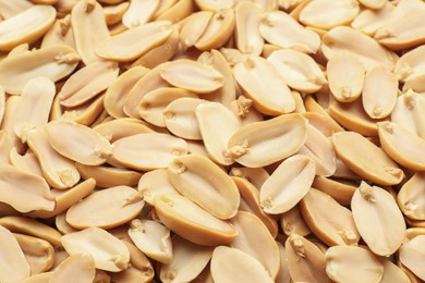 Fresh peeled peanuts as background, closeup view