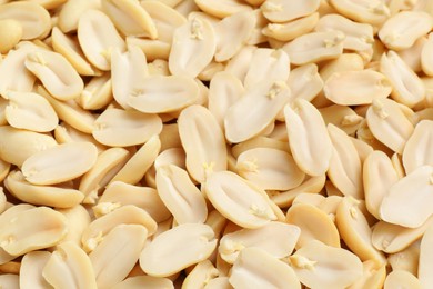 Fresh peeled peanuts as background, closeup view