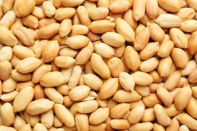 Photo of Fresh peeled peanuts as background, top view