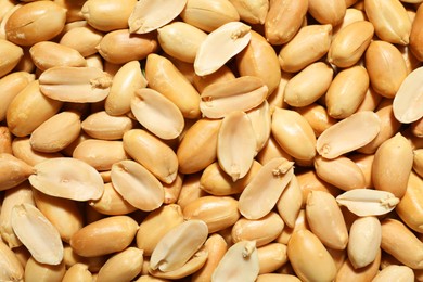 Fresh peeled peanuts as background, top view