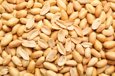 Photo of Fresh peeled peanuts as background, top view