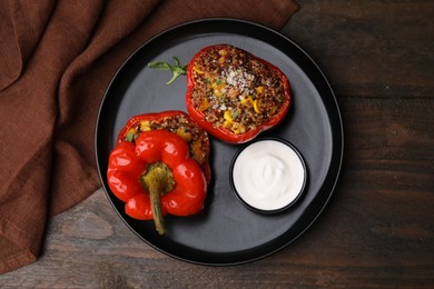 Photo of Quinoa stuffed peppers with corn on wooden table, top view