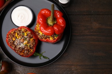 Photo of Quinoa stuffed peppers with corn on wooden table, flat lay. Space for text