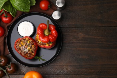 Photo of Quinoa stuffed peppers with corn on wooden table, flat lay. Space for text