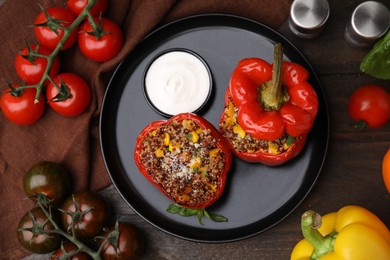 Photo of Quinoa stuffed peppers with corn on wooden table, flat lay