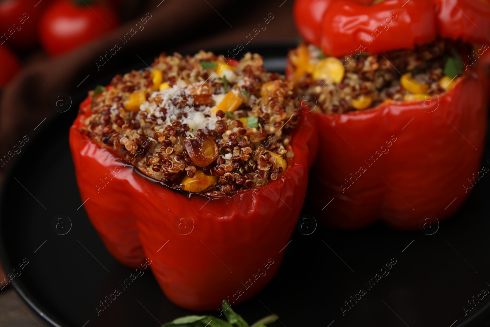 Photo of Quinoa stuffed peppers with corn on table, closeup