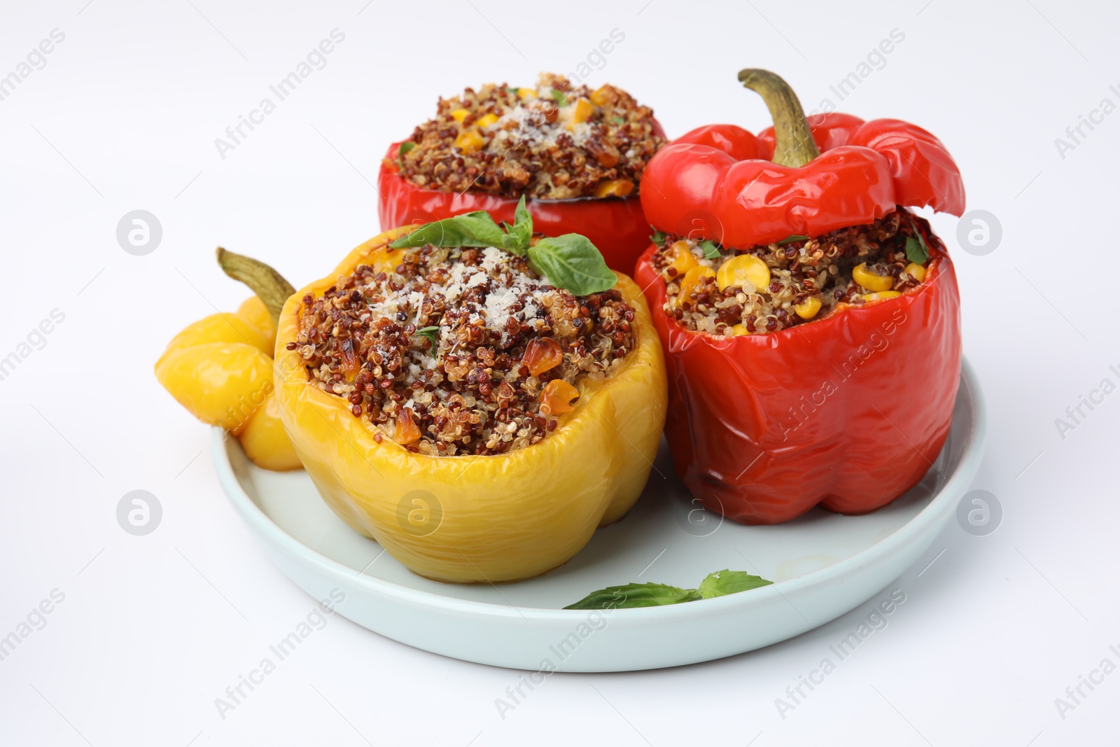 Photo of Quinoa stuffed bell peppers with corn and basil isolated on white