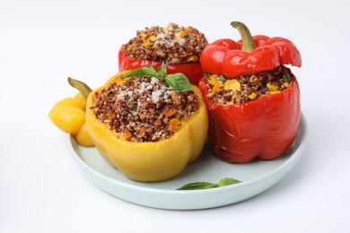 Photo of Quinoa stuffed bell peppers with corn and basil isolated on white