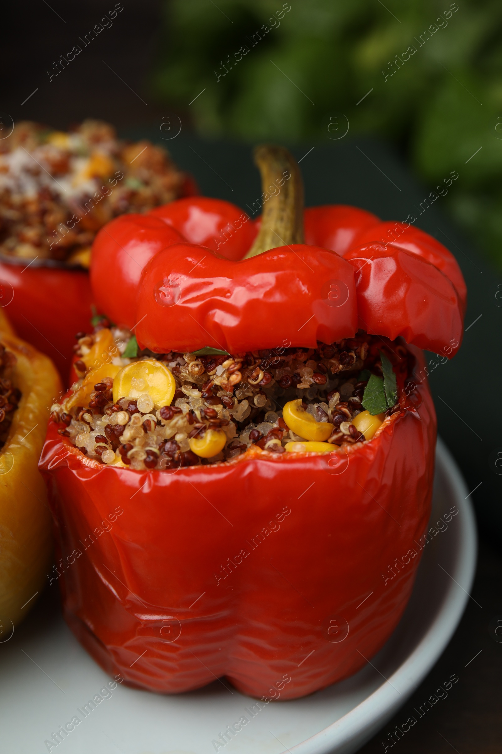 Photo of Quinoa stuffed peppers with corn on table, closeup