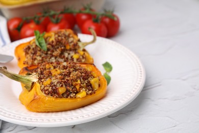 Photo of Quinoa stuffed peppers with corn and basil on white textured table