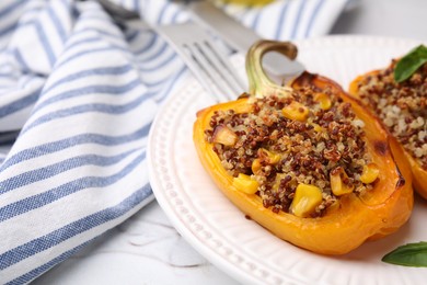 Photo of Quinoa stuffed peppers with corn and basil on white textured table, closeup