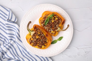 Photo of Quinoa stuffed peppers with corn and basil on white textured table, top view