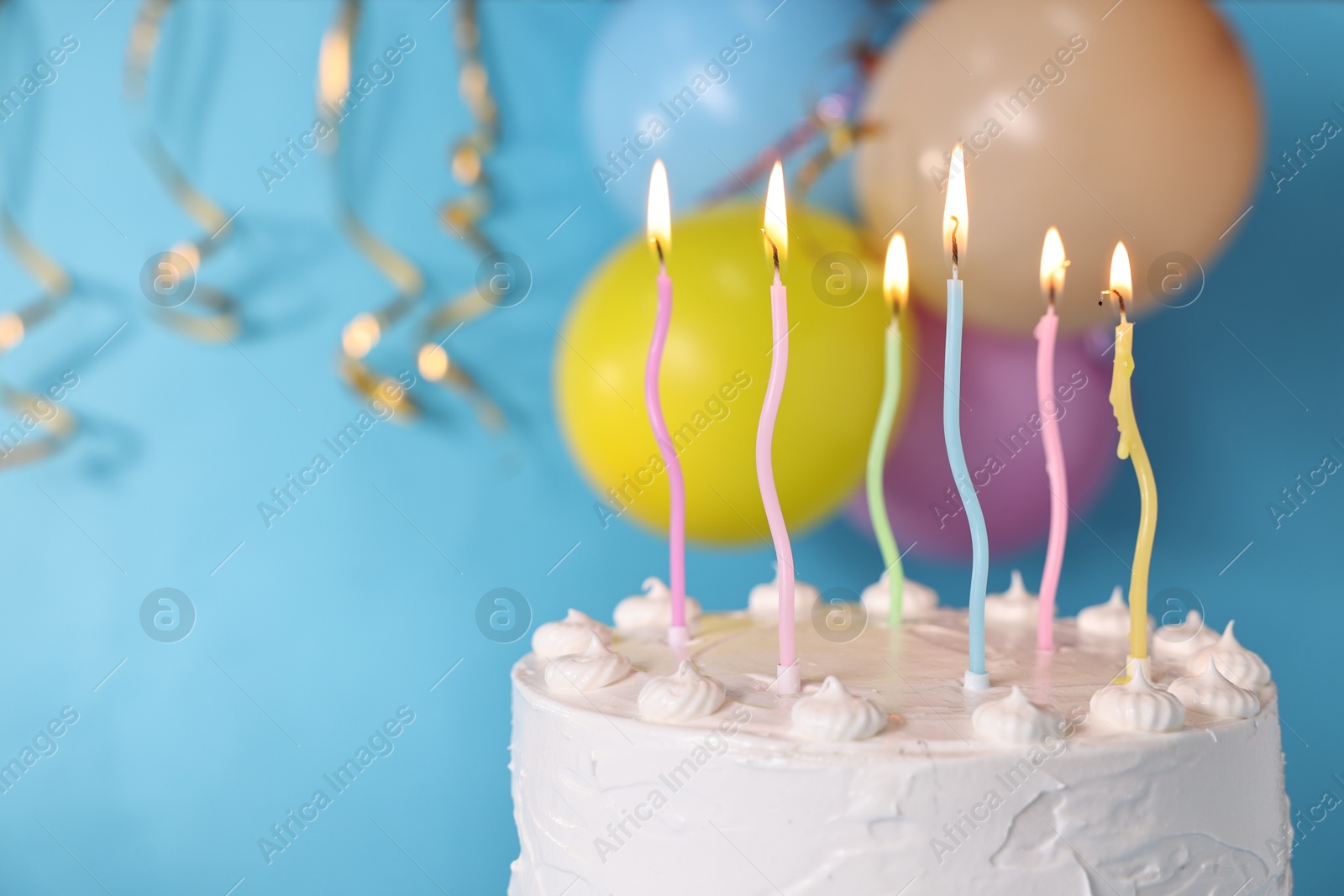 Photo of Tasty Birthday cake with burning candles against light blue background, closeup