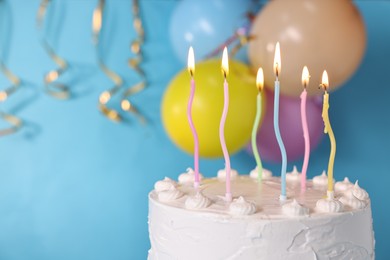 Photo of Tasty Birthday cake with burning candles against light blue background, closeup