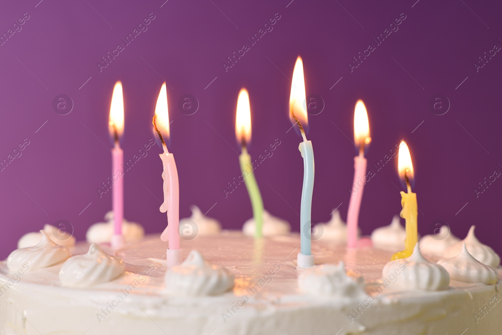 Photo of Tasty Birthday cake with burning candles against purple background, closeup