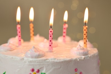 Photo of Tasty Birthday cake with burning candles against blurred background, closeup