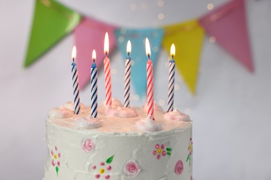 Photo of Tasty Birthday cake with burning candles against blurred background, closeup