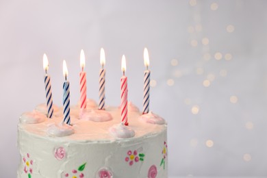 Photo of Tasty Birthday cake with burning candles against light grey background, closeup. Space for text