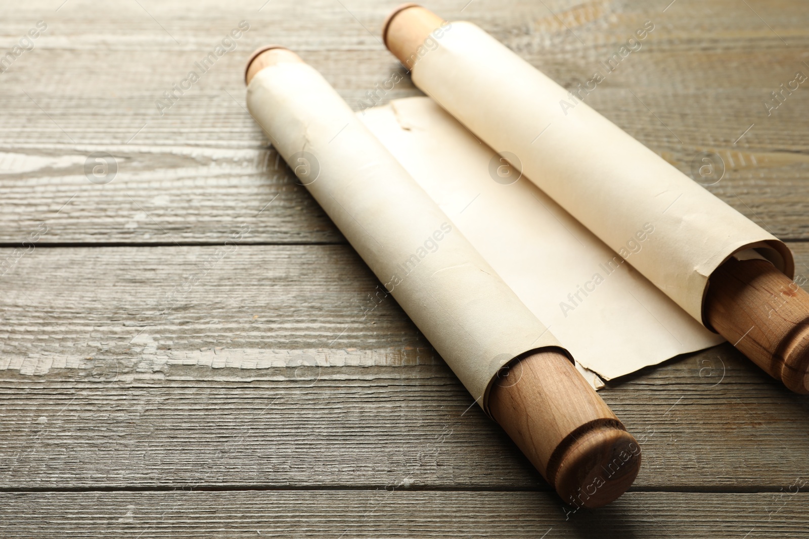 Photo of Sheet of old parchment paper with handles on wooden table, space for text