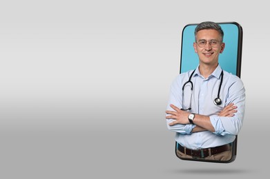 Online medical consultation. Doctor on smartphone screen against grey gradient background, space for text