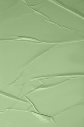 Image of Creased sage green paper as background, closeup