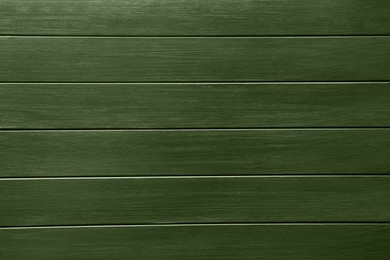 Sage green wooden surface as background, closeup