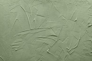 Sage green textured surface as background, closeup