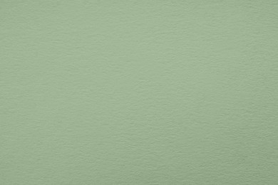 Sage green paper sheet as background, closeup