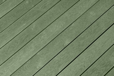 Sage green wooden surface as background, closeup