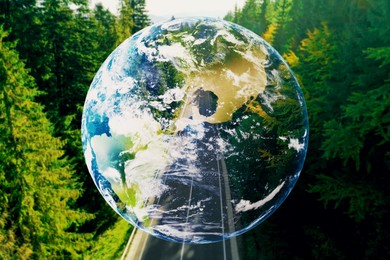 Image of Save the planet. Aerial view of coniferous forest and planet Earth, double exposure