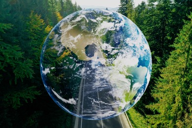 Save the planet. Aerial view of coniferous forest and planet Earth, double exposure