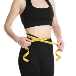 Woman with measuring tape showing her slim body against white background, closeup
