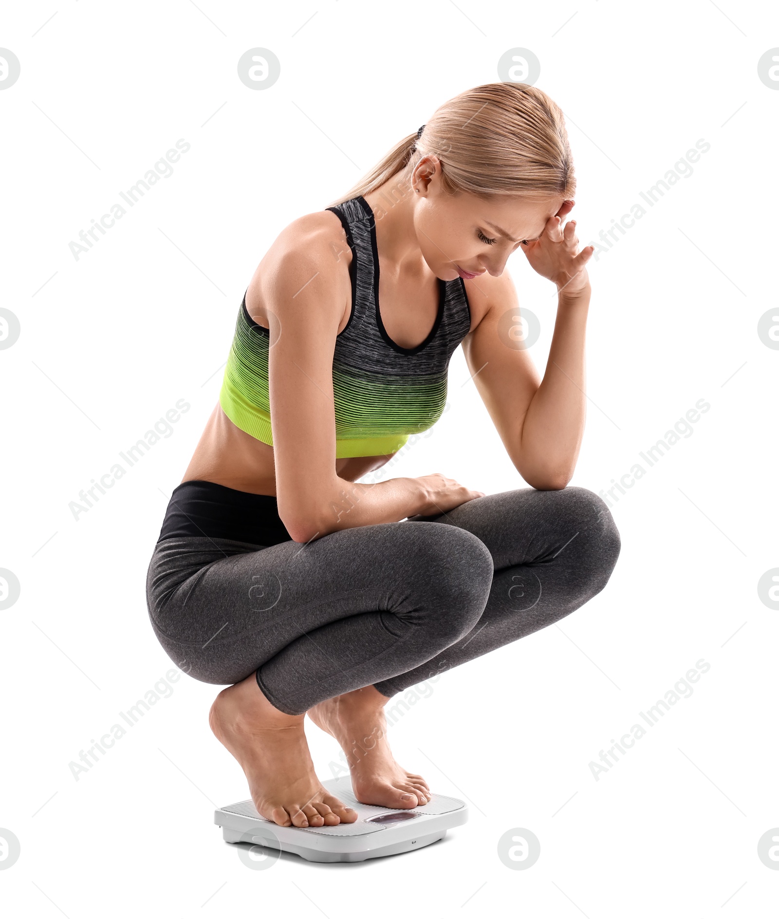 Photo of Upset woman on floor scale against white background