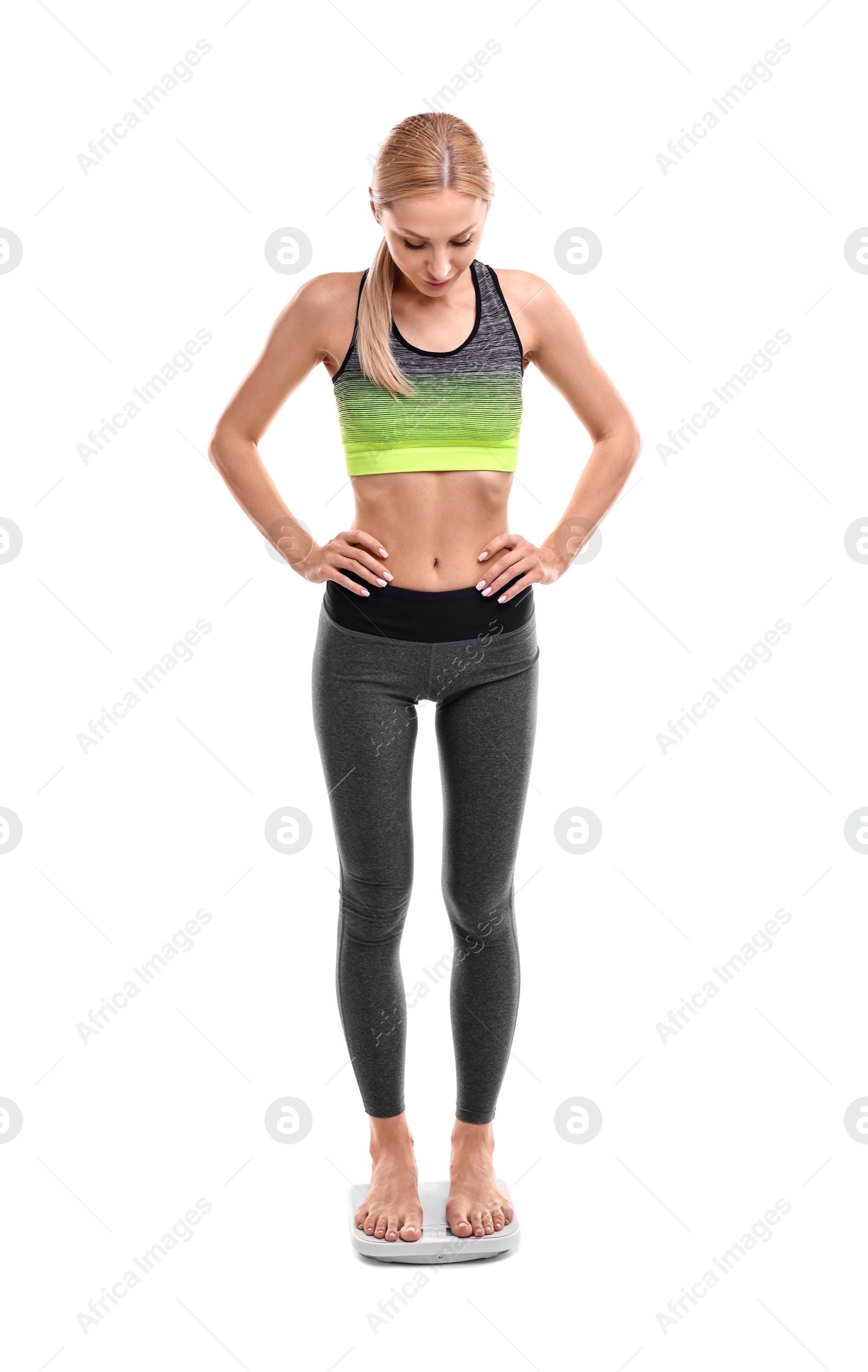 Photo of Woman standing on floor scale against white background