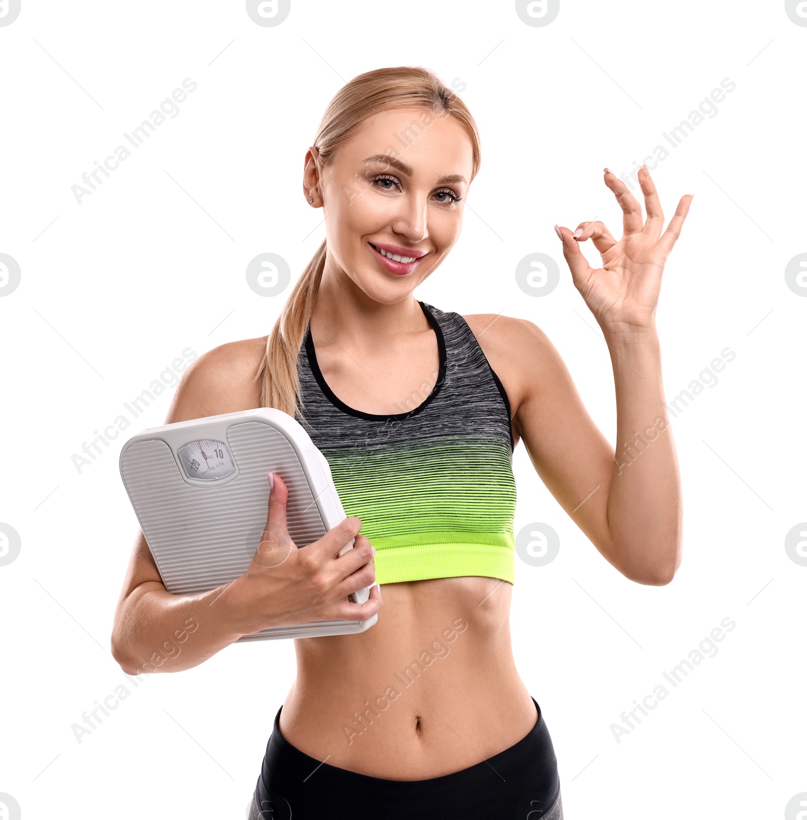 Photo of Happy woman with floor scale showing ok gesture on white background