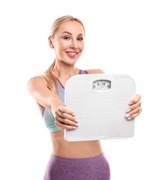 Happy woman with floor scale on white background