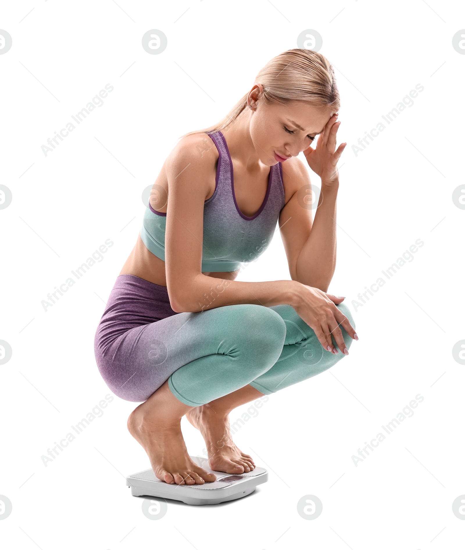 Photo of Upset woman on floor scale against white background