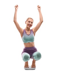 Happy woman on floor scale against white background