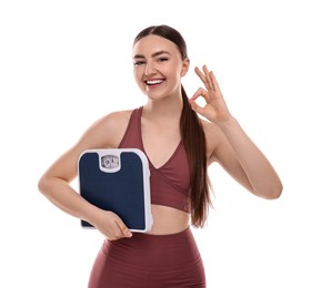 Photo of Happy woman with floor scale showing ok gesture on white background