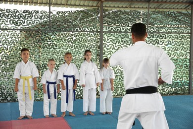 Children and coach during karate practice at outdoor gym
