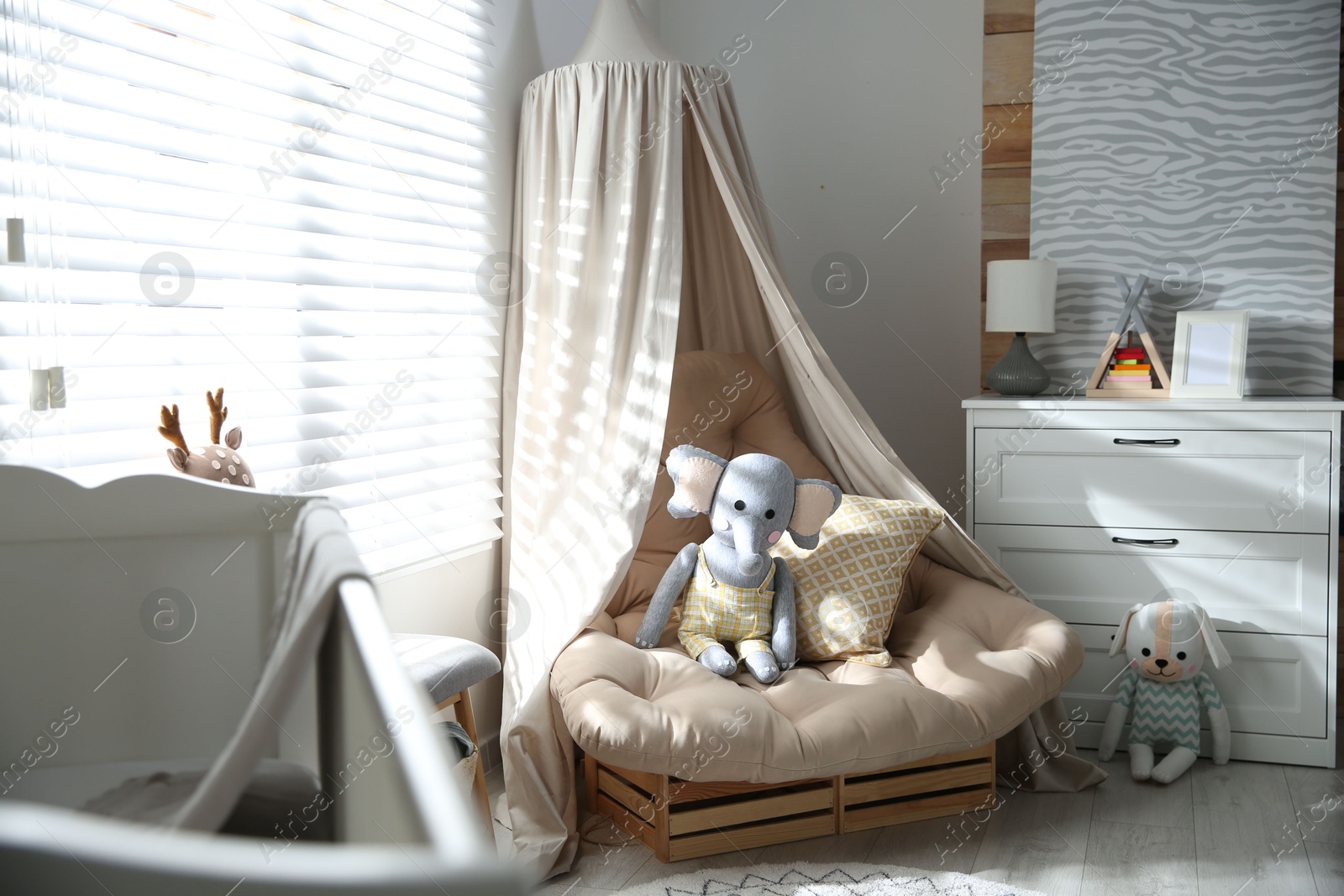 Photo of Comfortable armchair in modern baby room interior