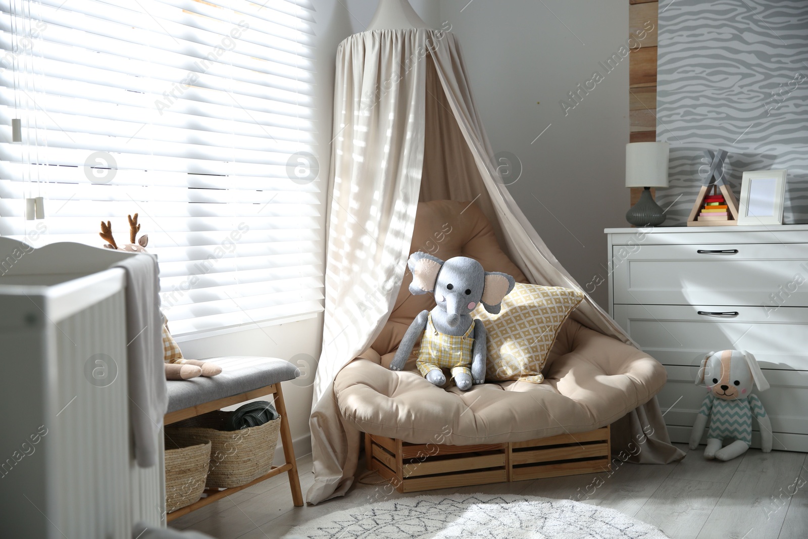 Photo of Comfortable armchair in modern baby room interior