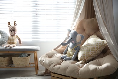 Photo of Comfortable armchair in modern baby room interior