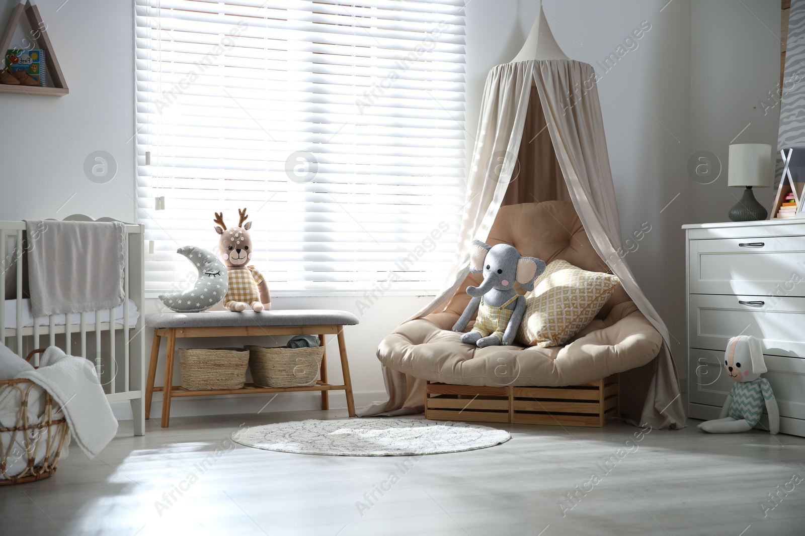 Photo of Comfortable armchair in modern baby room interior