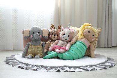 Photo of Funny stuffed toys on floor. Decor for children's room interior