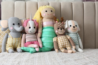 Different funny toys on bed. Decor for children's room interior