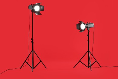 Red photo background and professional lighting equipment in studio