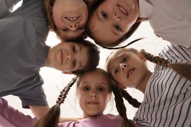 Photo of Group of cute little children indoors, bottom view