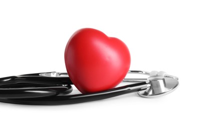 Stethoscope and red heart on wooden table against white background, space for text